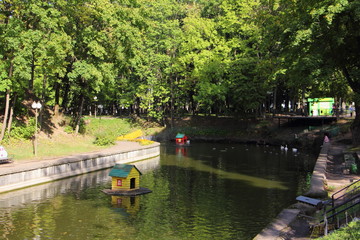 Smolensk, Russia, Pond in Park Lopatinsky Garden on green trees background on summer day