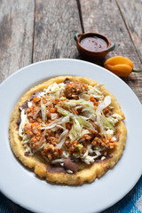 Mexican food: sopes of Picadillo beef with cheese and beans
