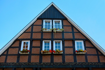 Traditional typical old house construction. Historic half timbered wooden german house facade.