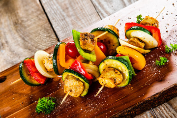 Grilled shashliks with chicken on cutting board