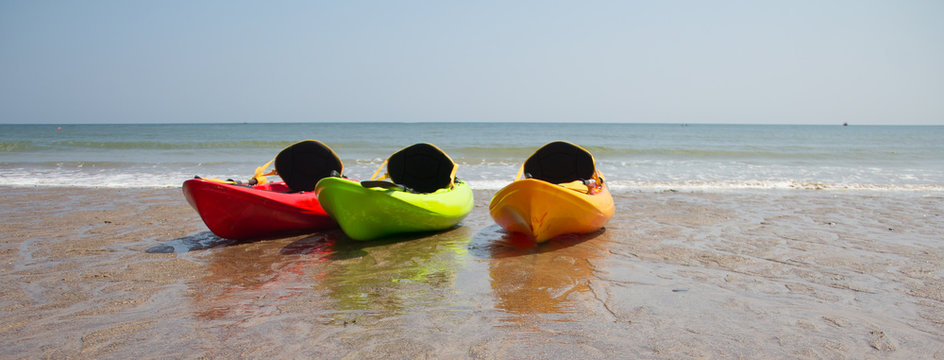 Boats on a beach in the summer time. 