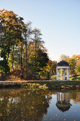 Autumn landscape of the lake surrounded by a city Park.