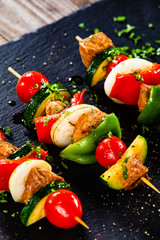 Grilled shashliks with chicken on blask stone plate © Jacek Chabraszewski
