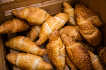 fresh delicious croissants in an open drawer