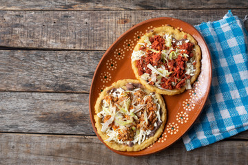 Mexican food: sopes of Chorizo and beef picadillo with cheese and beans