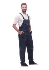 side view. smiling man in overalls looking forward to copy space