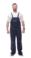confident young man in blue overalls . isolated on white