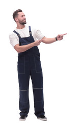 smiling man in overalls pointing to a copy of the space