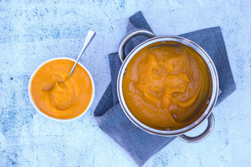 Obraz na płótnie Canvas Cooked yellow pumpkin puree with in bowl. Vegan, vegetarian. Creamy.