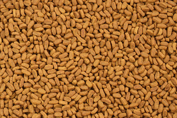 Dry food for cats or dogs. Granules of oblong form. Top view 