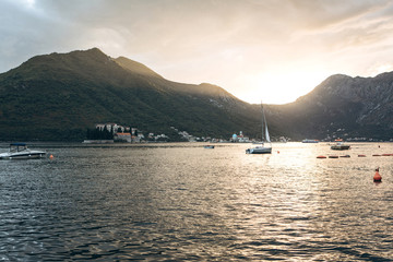 Beautiful view of the Kotor Bay in Montenegro at sunset. Natural mountain landscape and sea with boats or yachts.