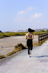 Happy sporty woman jogging outdoors