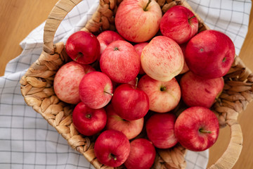 Fresh red apples in a basket on the table, which are very useful for a diet. Harvesting, apple spas.