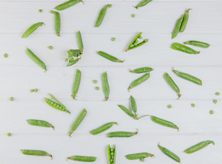 Food photography. Peas scattered on a white board