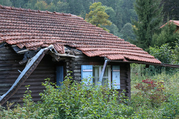Old wooden house in disrepair on the edge of the village