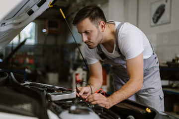 Auto mechanic working on car diagnostic in a repair shop