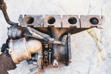 Intake manifold on the floor of the garage - auto repair shop