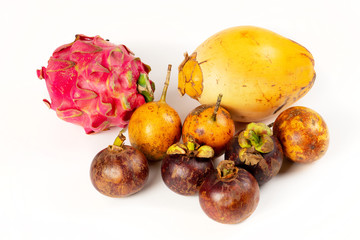 Exotic fruits on white background: dragon fruit, coconut, passion fruit and mangosteens