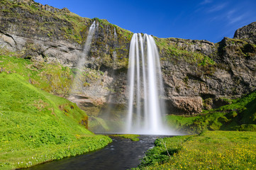 Icelandic waterfall. Scenery long exposure photo of Seljalandsfoss waterfall in sunny day