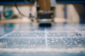 Milling cutter cuts plastic part on robotized production line. Factory robots used to produce...