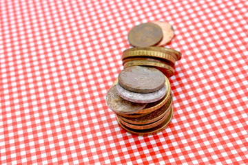 coins on red stripped background