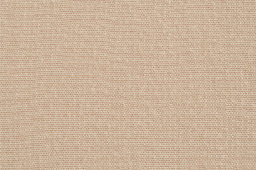 Fototapeta na wymiar Beige knitted fabric texture. Soft jersey background. Closeup