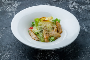 Salad caesar with chicken on white plate
