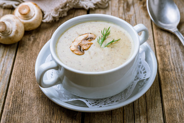 Cream soup of mushrooms on wooden table