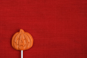 Halloween lollipop on red texture background