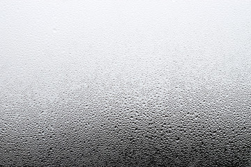 Steamy window background. Drops of condensate on the glass