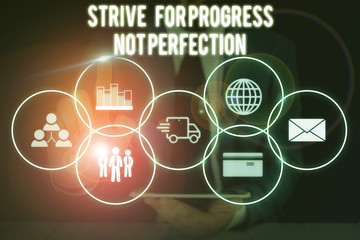 Conceptual hand writing showing Strive For Progress Not Perfection. Concept meaning Improve with flexibility Advance Grow Male wear formal suit presenting presentation smart device