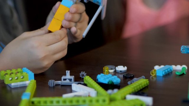 Children in the classroom make figure from the designer