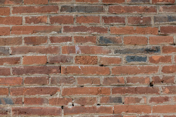 Red clinker brick wall of an old building