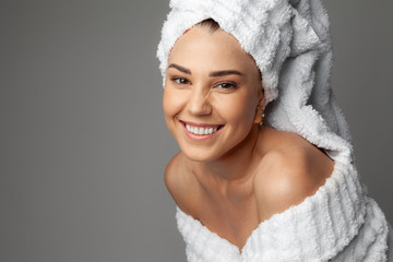 Young woman in a bathrobe and towel on her head