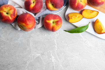 Flat lay composition with fresh peaches and space for text on marble background