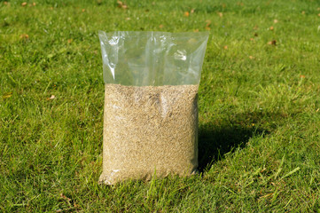 Foil packaging with grass seeds. Lawn installation.