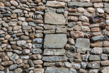 Natural stone wall with colorful and different sized stones