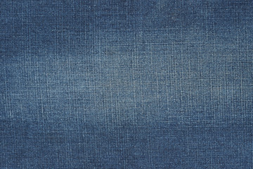 Denim fabric texture. Faded jeans background. 