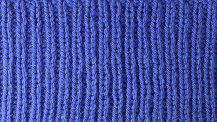 Blue wool yarn knitted texture with large stitches. Hand knitted ribbing stitch pattern