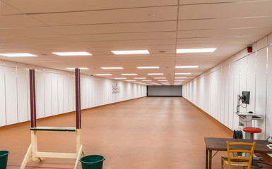 in a large indoor shooting range can train sport shooters