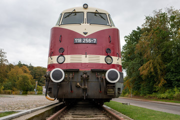 an old historical train of the Deutsche Reichsbahn from the times of the GDR stands on a siding