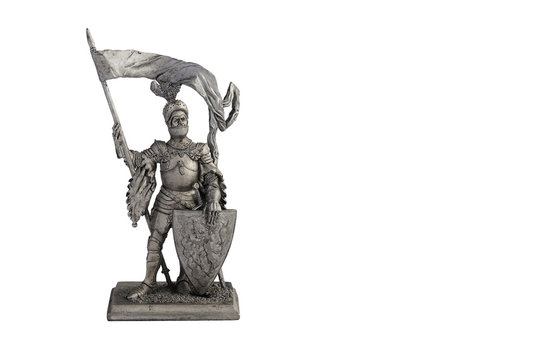European knight  sword and shield. Tin statue toy isolated on white. Copy space