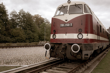 an old historical train of the Deutsche Reichsbahn from the times of the GDR stands on a siding
