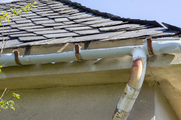 Old gutter. A broken gutter on the roof of a house