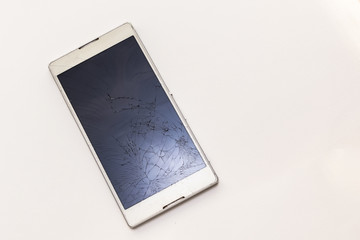 broken phone with cracked screen white modern phone
