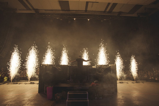 Sparks fly in front of DJ on stage