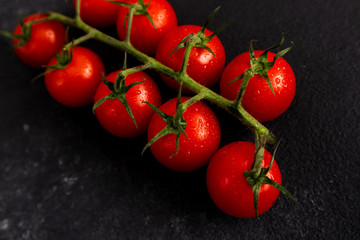 Red tomatoes on a black background