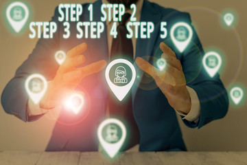 Conceptual hand writing showing Step 1, 2, 3, 4 and 5. Concept meaning Steps levels of a process work flow Male wear formal suit presenting presentation smart device