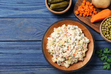 Delicious salad Olivier on blue wooden table, flat lay. Space for text