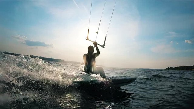 A man is kiteboarding across the water